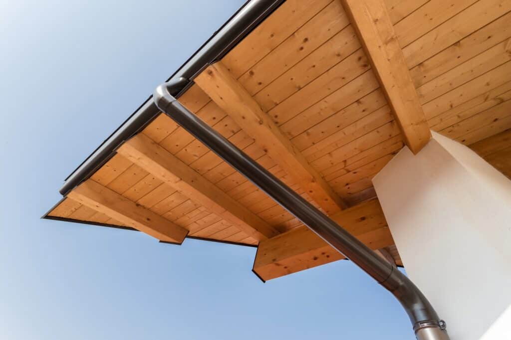New wooden warm ecological house roof with steel gutter rain system